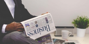 man reading business section of newspaper