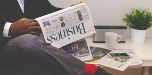 man reading business section of newspaper