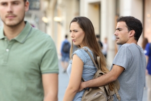 Disloyal woman looking at another man