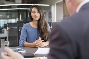 Focused Indian female meeting with financial advisor